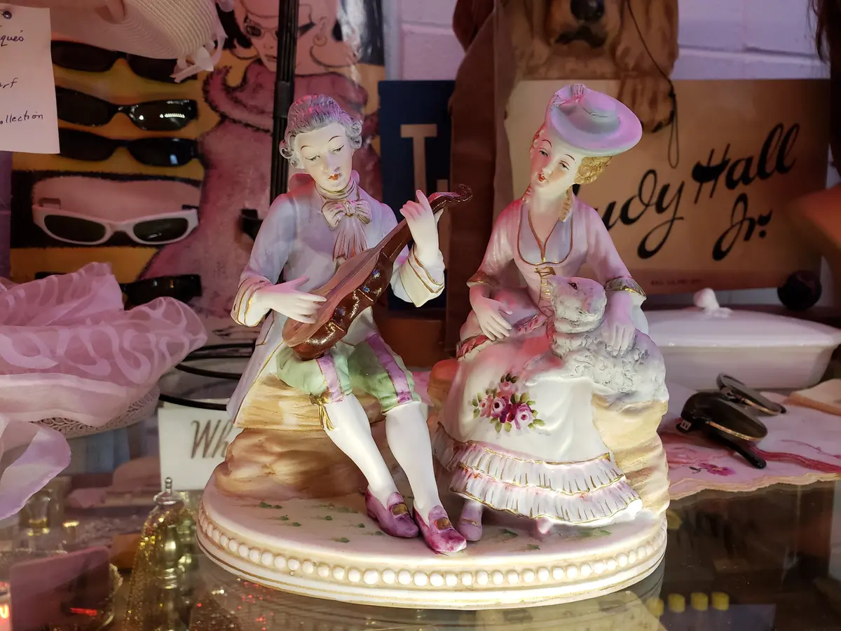 Man Playing Instrument To Lady With Sheep Figurine 1